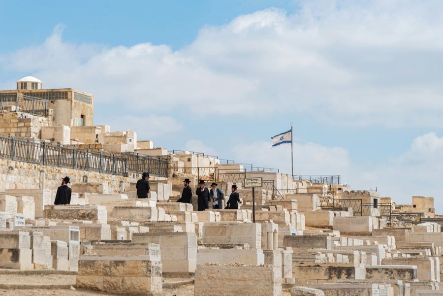 Jerusalem hillside with Hebrew inscriptions and an Israeli flag