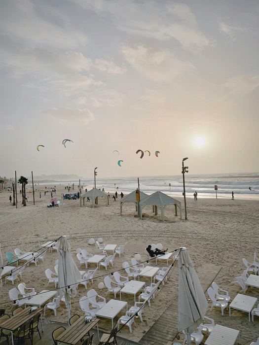 Tel Aviv beach with kites and cafe tables